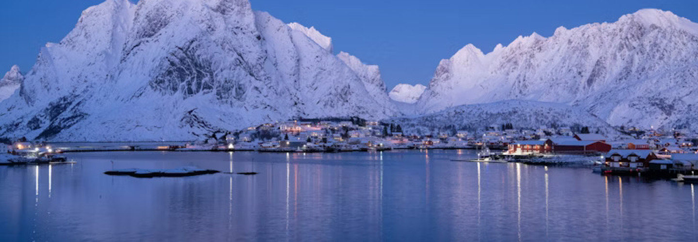 Snötäckta berg vid en sjöstad